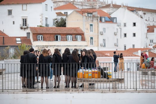 21 April 2023 Lisbon, Portugal: Alfama - Group of girls students celebrate the student holidays with many homemade alcohol drinks. Mid shot