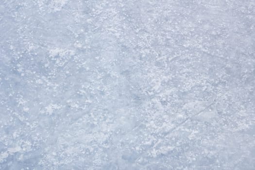 Ice background with skating and hockey marks, blue texture.
