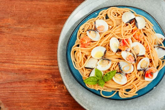 Pasta with clams and spaghetti on a light background. Traditional italian seafood pasta