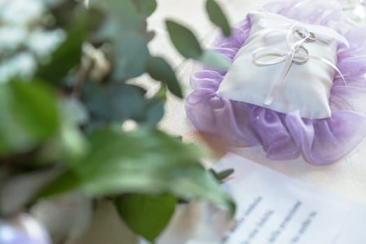 Wedding rings on a pillow as wedding symbol.