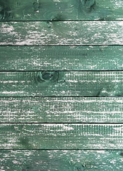 Old green wooden wall with cracked paint, background texture.