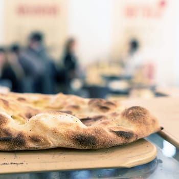Pizzeria. Beautiful traditional focaccia. Fresh bread. Focaccia on wooden cutting board.