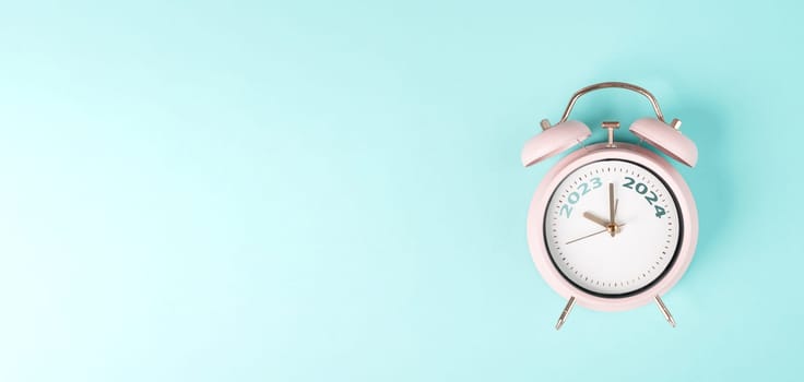 New year 2024 is loading, calendar date on an alarm clock, end of the year, changing time