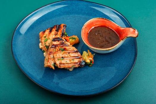 Grilled tuna steak served with vegetables salad on a plate