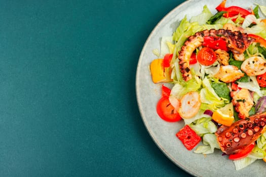 Tasty salad of fresh vegetables and octopus tentacles. Octopus salad. Copy space