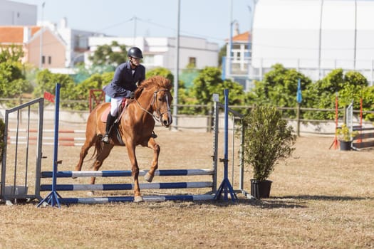 30 april 2023 Sobreda, Portugal: Festival Hipico da Sobreda - a man riding a horse at ranch. Mid shot