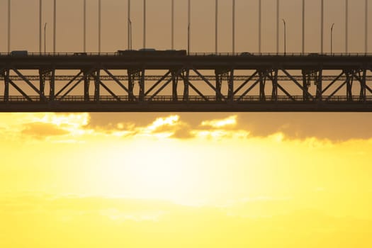 Bridge - Ponte 25 de Abril Lisbon Portugal - 25 april Bridge, cars and tracks moving over the bridge at sunrise, morning