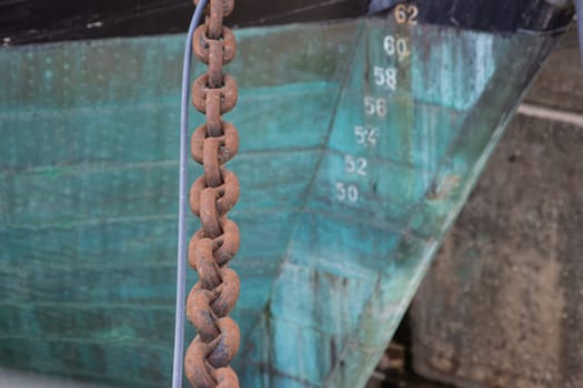 Anchor chain of historical battleship in port of Lisbon, daylight