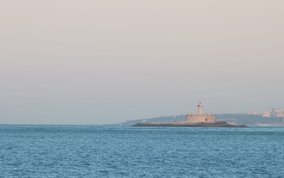 lighthouse at sunrise - coast of Portugal, island on the ocean at morning