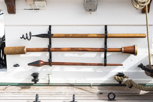Historirical old cannon on battle sailing vessel - ramrod, brush - stand on the deck