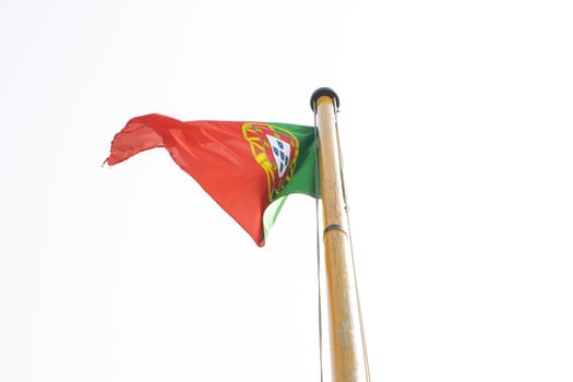 Waving National flag of Portugal in the wind on ship's mast in front of the sky
