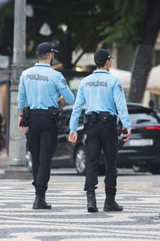 Two policemen on the streets of Lisbon. Vertical shot