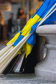Ukrainian flags leaning against the column. Vertical shot
