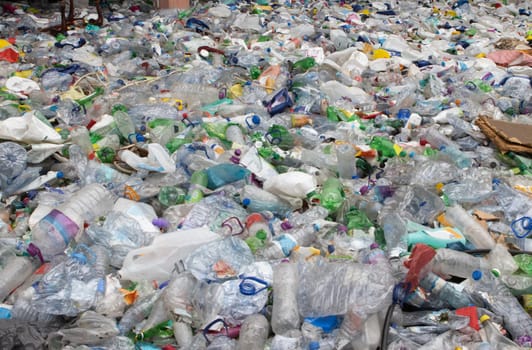 A bunch of empty plastic bottles in a landfill. Mid shot
