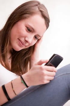 young girl focused on texting with her mobile phone