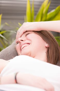 very happy girl laughing on her sofa