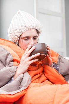 funny exaggeration concept of an ill woman that has the flu as she drinks a hot chicken broth