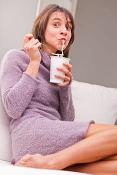 happy woman slurping her noodles in relax