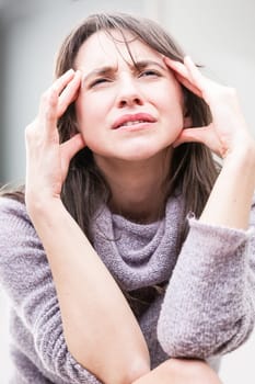 woman has a strong headache or head cold