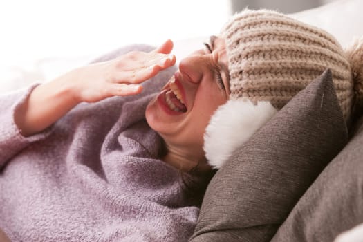 headache and illness of a young woman on a couch in her living room