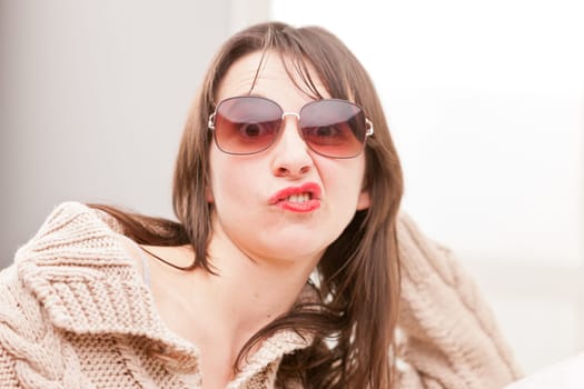 woman with sunglasses making funny faces (perplexed)