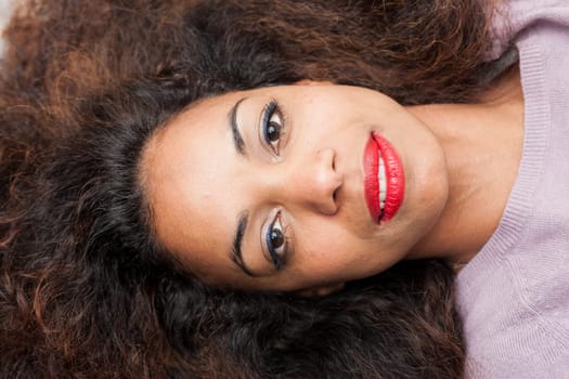 frontal portrait of a lying beautiful afroamerican woman's face