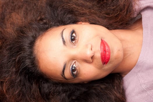 wonderful african-american woman lying on a sofa relaxing