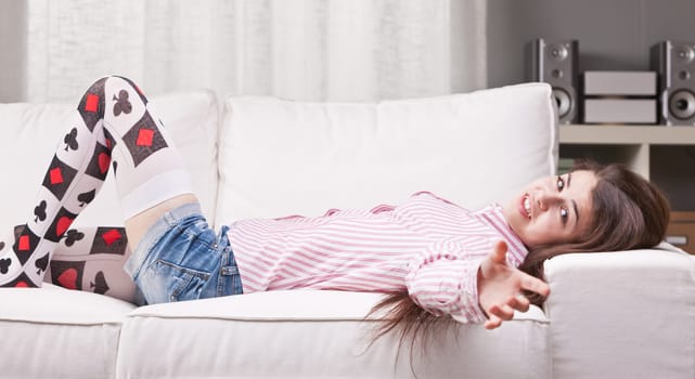 girl talking to the camera from a couch in her living room