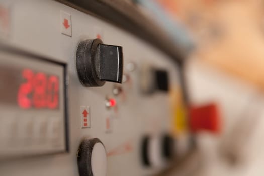 detail of a switch in a carpenter workshop with a very shallow depth of field