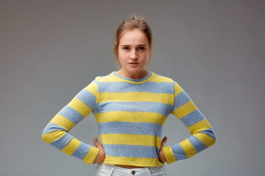 Ugh! I am very angry! Portrait of a beautiful and very angry young woman. She has her hands on her hips and is waiting for you to lecture you.