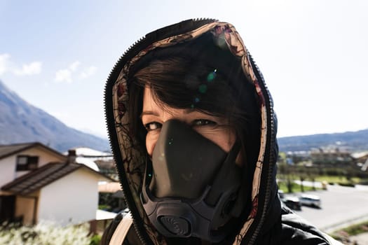 woman with a gas mask walking on the city streets surviving a corona virus pandemic or post atomic world