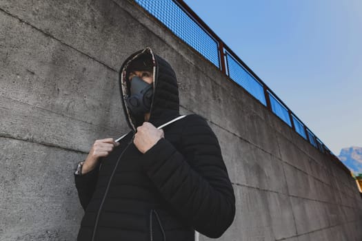 woman with a gas mask walking on the city streets surviving a corona virus pandemic or post atomic world