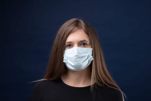 young woman correctly wearing a surgical mask protecting herself and her community from pandemic spreading risks