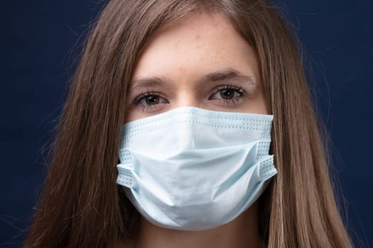 young woman correctly wearing a surgical mask protecting herself and her community from pandemic spreading risks