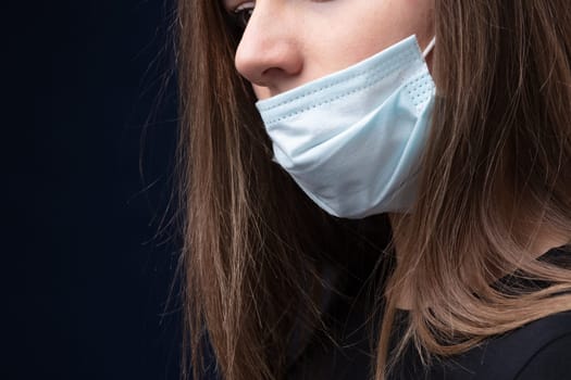 woman wearing a surgical mask the wrong way leaving her nose out