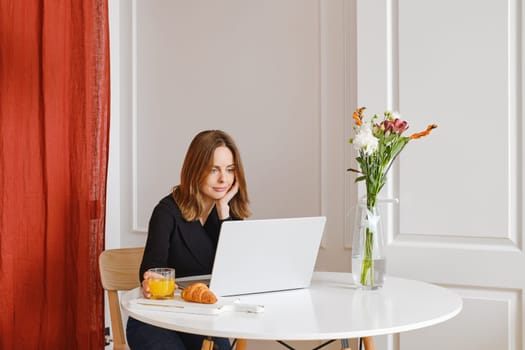 Woman watching movie on laptop at home