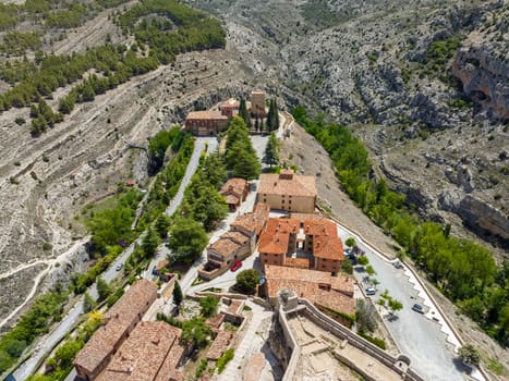Auditorium church of Santa Maria next to the white surveillance tower in Albarracin, province of Teruel listed as beautiful towns of Spain