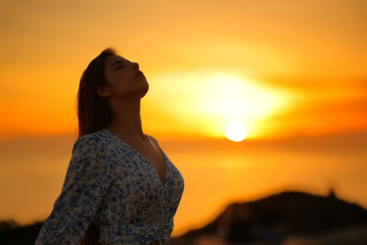 Relaxed woman breathing fresh air on the beach at sunrise