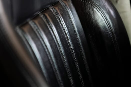 Close-up showcasing the intricate texture and design of a leather seat in a sports car.