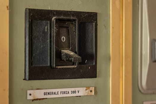 Close-up of aged, obsolete high-voltage electrical switches with a nostalgic industrial feel.