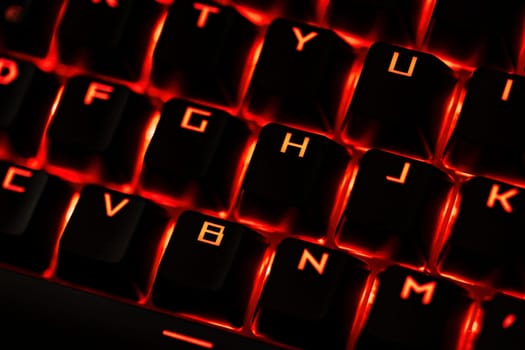 Close-up of a gaming keyboard with illuminated backlit keys, highlighting precision and design.