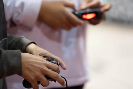 Trying new console games using joysticks at game expo. Mid shot