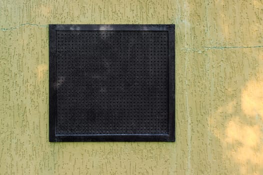 Air ventilation frame on wall of the small factory.