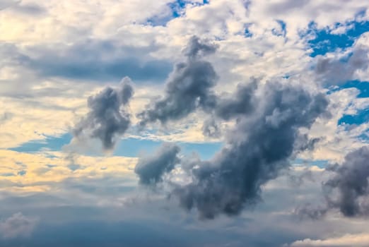 cumulus white clouds against a beautiful blue sky, bizarre patterns