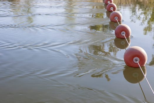 Buoy rope stretched over the current of irrigation canal. Vegas Altas del Guadiana, Badajoz, Extremadura, Spain