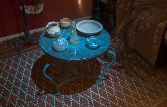 Almendralejo, Spain - Jan 26th, 2018: Roman domestic room with containers to pour wine. Wine Science Museum, Almendralejo, Spain