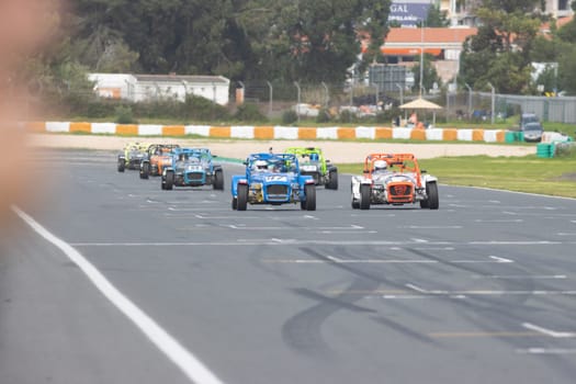 11-20-2022 PORTUGAL, LISBON: Caterham Festival Estoril - racing karts of different colors drive along the race track. Mid shot