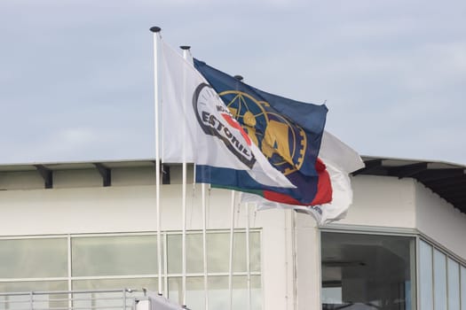 11-20-2022 PORTUGAL, LISBON: Caterham Festival Estoril - advertising flags fluttering in the wind. Mid shot
