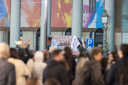 PORTUGAL, LISBON 11-25-2022: the March for the End of Violence Against Women - women hang a poster on poles. Mid shot