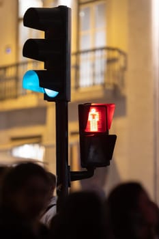 Traffic lights are red and blue on the street. Mid shot